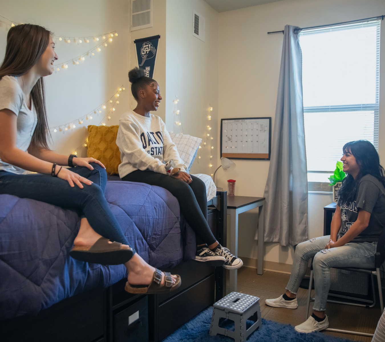 Students laughing in dorm room