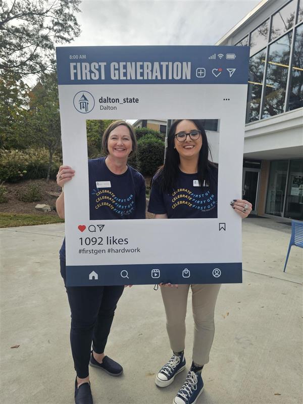 Two women hold sign that says First Generation