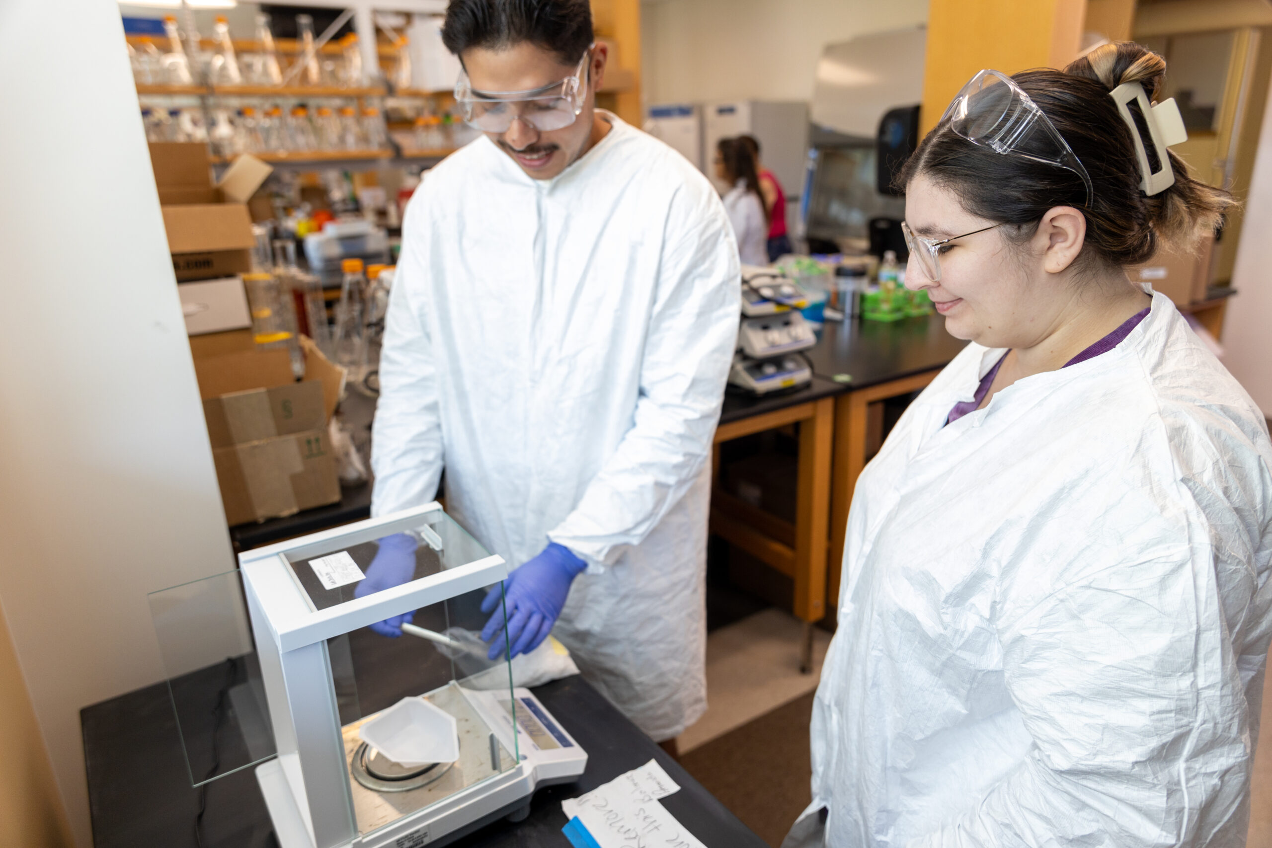 Male and female dalton state student work on experiment